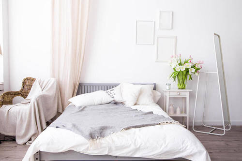 Letto con lenzuola e coperte in materiali naturali