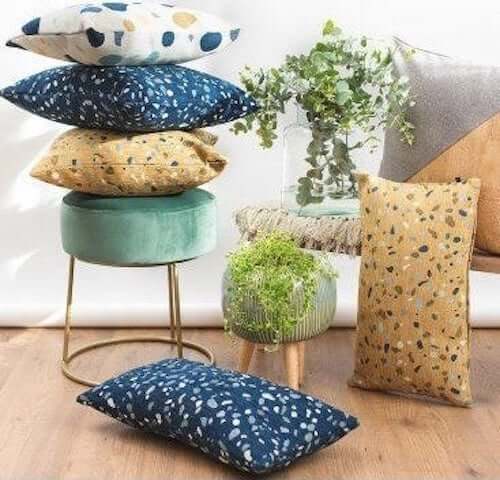 Cuscini con tessuti con trama a graniglia.